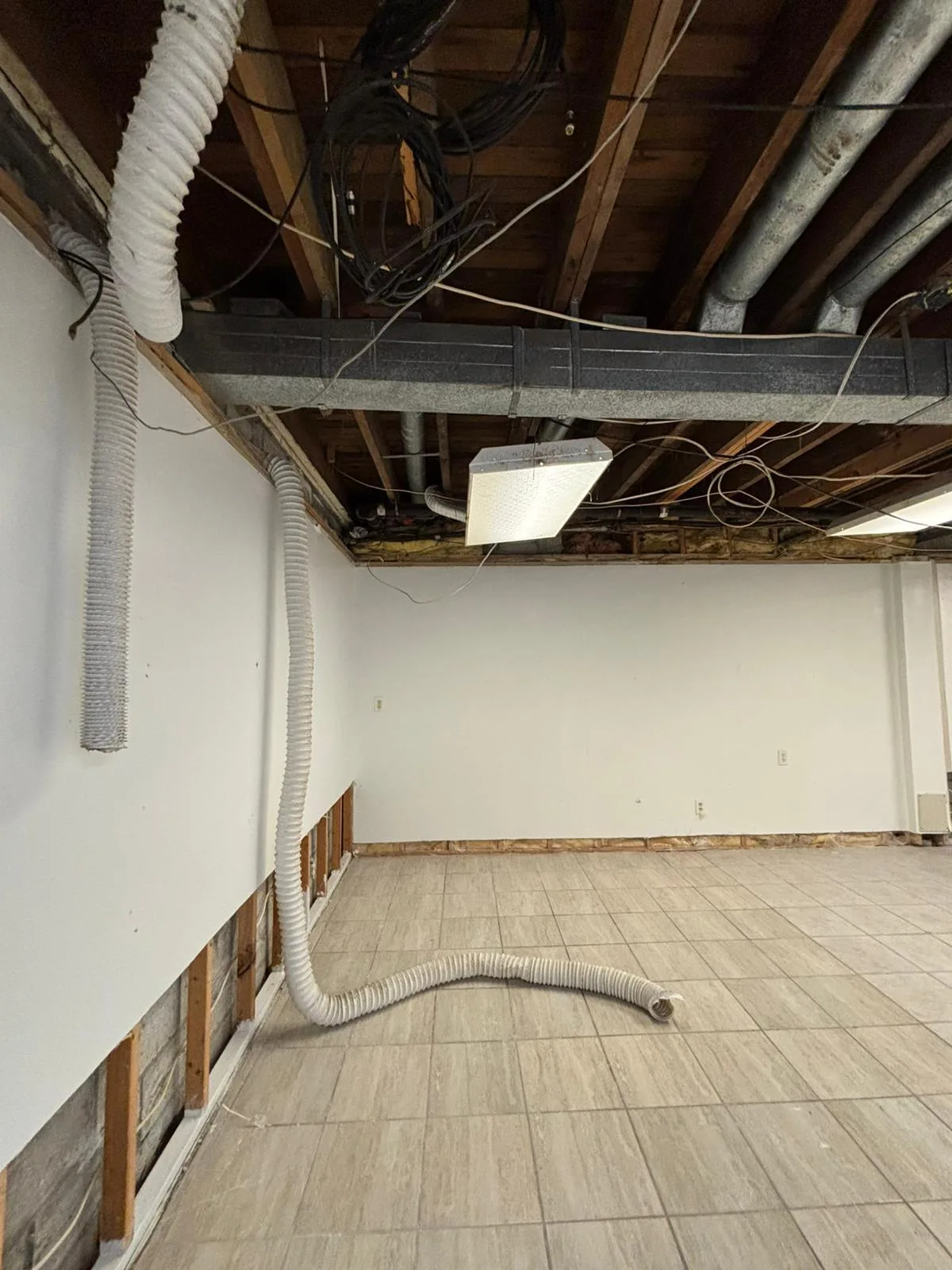 Commercial interior before renovation, set 3: stripped-back walls and exposed ceiling