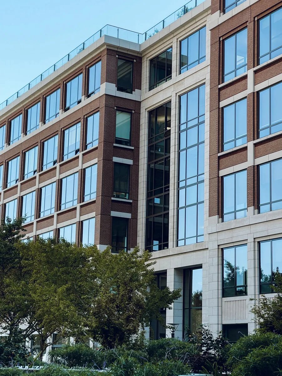 Modern multi-storey office building with landscaped grounds