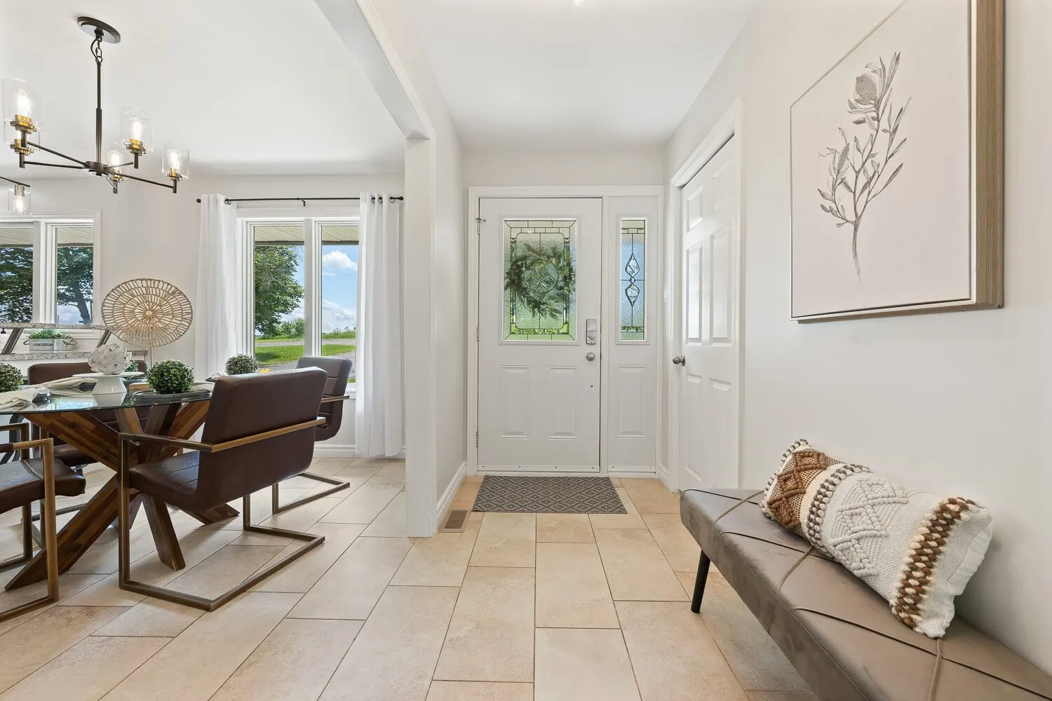 Bright dining area and entry with tile flooring in a Durham Region home